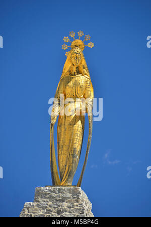 Gold statue of the Virgin Mary on the summit of the Monte Moro Pass in the Italian alps above Macugnaga Stock Photo