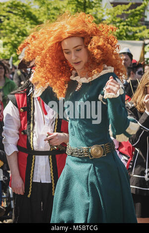 April  19, 2014, Haarzuilens, The Netherlands: Beautiful young woman with red wig is dancing during the Elf Fantasy Fair (Elfia), an outdoor fantasy e Stock Photo