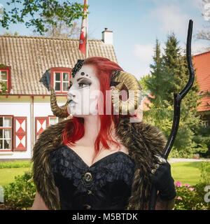 April  19, 2014, Haarzuilens, The Netherlands: Beautiful red haired woman wearing ram horns at the Elf Fantasy Fair (Elfia), an outdoor fantasy event  Stock Photo