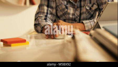 Old people, medical condition and health. Busy senior woman suffering for carpal tunnel syndrome while using computer mouse. Stock Photo