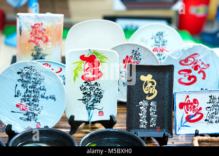 Written speaker sentence Lunar New Year art of ceramics with text 'Happy, Merit, Fortune, Longevity, Peace' in Vietnamese used to decorate indoors Stock Photo