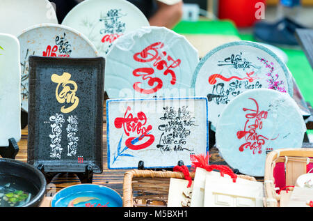 Written speaker sentence Lunar New Year art of ceramics with text 'Happy, Merit, Fortune, Longevity, Peace' in Vietnamese used to decorate indoors Stock Photo