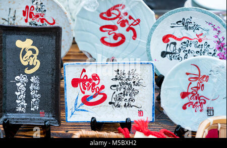 Written speaker sentence Lunar New Year art of ceramics with text 'Happy, Merit, Fortune, Longevity, Peace' in Vietnamese used to decorate indoors Stock Photo