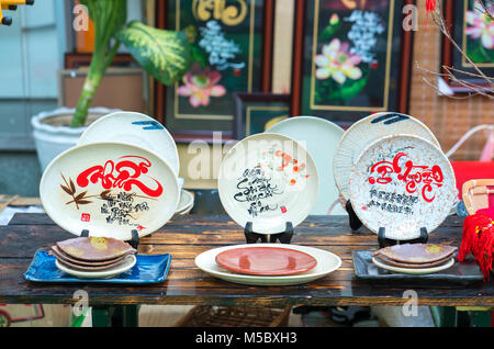 Written speaker sentence Lunar New Year art of ceramics with text 'Happy, Merit, Fortune, Longevity, Peace' in Vietnamese used to decorate indoors Stock Photo