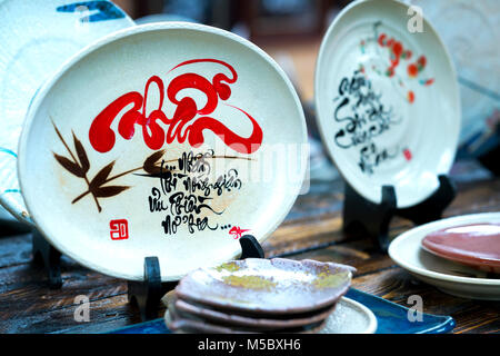 Written speaker sentence Lunar New Year art of ceramics with text 'Happy, Merit, Fortune, Longevity, Peace' in Vietnamese used to decorate indoors Stock Photo