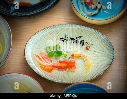 Written speaker sentence Lunar New Year art of ceramics with text 'Happy, Merit, Fortune, Longevity, Peace' in Vietnamese used to decorate indoors Stock Photo