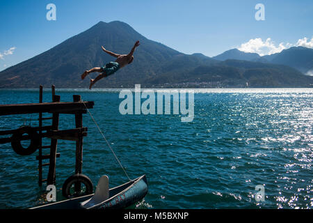 A man jumps into Lake Atitlan in Guatemala. Stock Photo