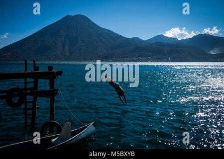 A man jumps into Lake Atitlan in Guatemala. Stock Photo