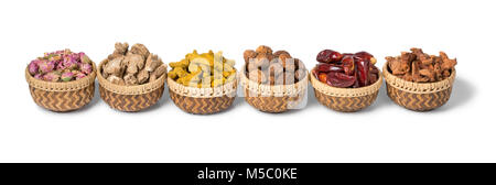 Row of baskets with traditional North African dried herbs isolated on white background Stock Photo