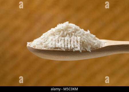 Wooden spoon with raw basmati rice Stock Photo