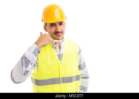Construction company contact person concept with handsome friendly engineer making call us gesture isolated on white background Stock Photo