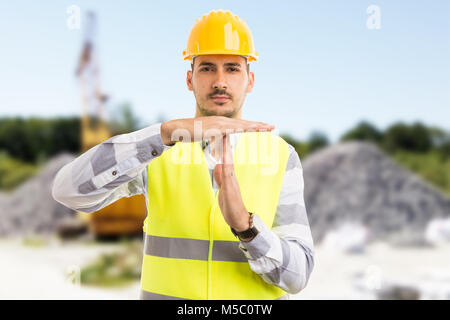 Architect or engineer making time out pause break gesture on construction site or pit outdoors Stock Photo