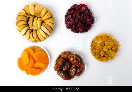 Various dried fruits in small bowls top view, healthy snacks Stock Photo