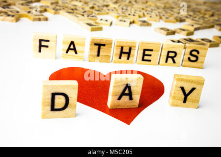 Fathers Day wooden letters on a white background. One red heart Stock Photo