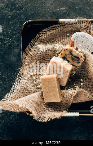 top view of natural homemade soap and pumice for spa on sacking in tray Stock Photo