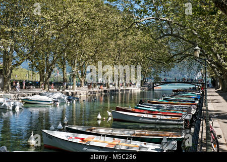 Pleasure boats are mored on the Canal du Vasse for hiring out to tourists and visitors on holiday in Annecy. Stock Photo
