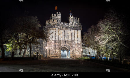 Lancaster, England, UK - November 11, 2017: The main gatehouse of the mediaeval Lancaster Castle is lit up at night. Stock Photo