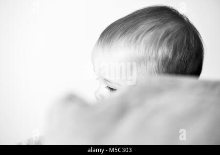 Cute baby girl toddler portrait playing hide and seek Stock Photo