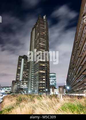 London, England, UK - February 8, 2018: Shakespeare Tower, one of the residential high rise tower blocks of the brutalist Barbican Estate, is lit up a Stock Photo