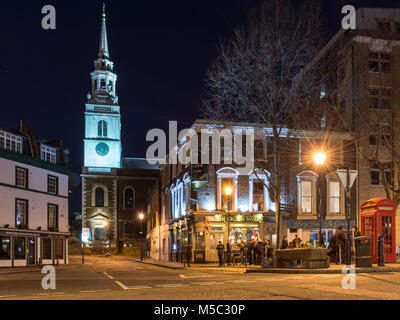 London, England, UK - February 9, 2018: The spire of St James's Church is lit up at night on Clerkenwell Green in central London. Stock Photo