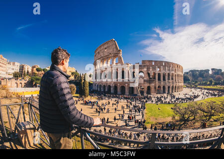 Male tourist enjyoing the view at the Colosseum in Rome, Italy Stock Photo