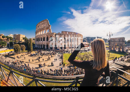 Woman tourist looking at the Roman Colosseum in Rome, Italy Stock Photo