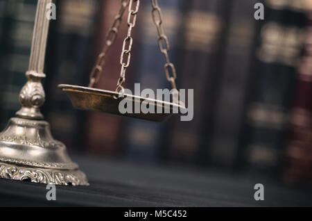 Law and Justice, Legality concept, Scales of Justice on a black wooden background. Stock Photo