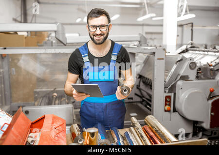 Worker with stamping foil rolls at the manufacturing Stock Photo