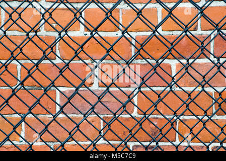 Block wall behind chain link fence background Stock Photo - Alamy