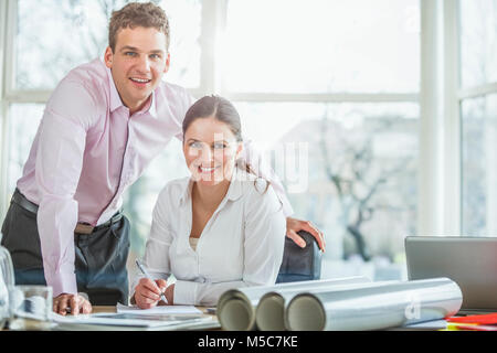Portrait of young architects working together at office desk Stock Photo