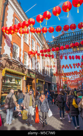 Colourful lanterns and a throng of people in Gerrard Street, Chinatown, to celebrate Chinese New Year. Westminster, London W1, England, UK. Stock Photo