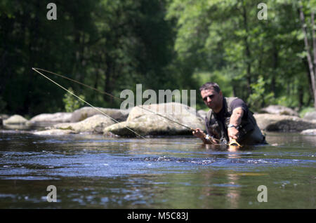 Fly fishermen in a trout river. Fly fishing scene Stock Photo