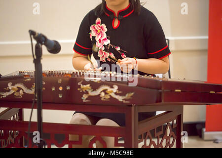 Girl is playing Chinese cymbalo. Stock Photo