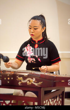 Girl is playing Chinese cymbalo. Stock Photo