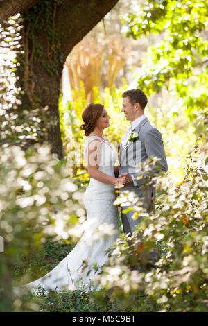 Newly married couple having private moment in the garden Stock Photo