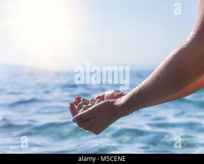 Sea pebbles in the hand. Stock Photo