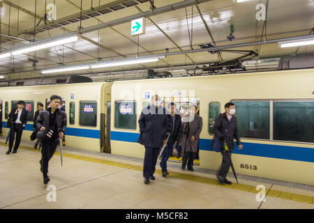 Morning commuters arriving at Shinjuku Station in the centre of Tokyo Stock Photo