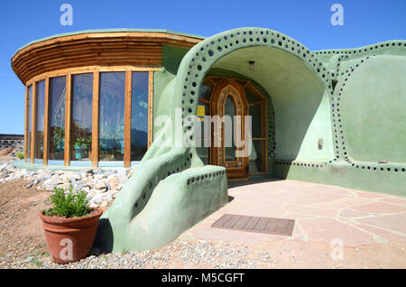 Entrance of an Earthship sustainable house made out of adobe and upcycled glass bottles near Taos in New Mexico, USA Stock Photo