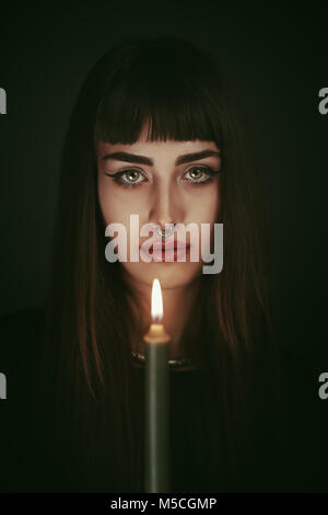Modern witch. Candle light portrait Stock Photo