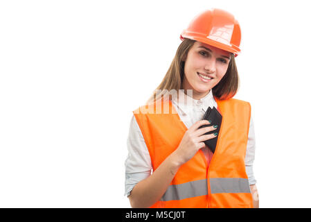 Woman engineer taking out wallet with money from her pocket to can pay something on white background Stock Photo