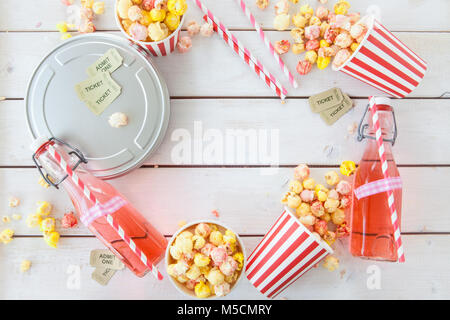 Colorful popcorn in striped cups and lemonade in vintage bottles Stock Photo