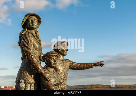 Statue of Annie Moore in Cobh, County Cork, Ireland, with her brothers, first Irish immigrant to the United States in 1892 with copy space. Stock Photo