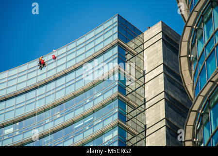 MILAN, ITALY - SEPTEMBER 19,2017: Climber workers for glass cleaning at Porta Garibaldi district, Piazza Gae Aulenti. Stock Photo