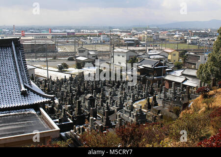 Translation: 'Japanese cemetery' around Hizen-Yamaguchi station, Japan. Big statue behind. Taken in February 2018. Stock Photo