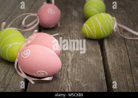 Painted easter eggs on wooden rustic board.  Selective focus, close up. Stock Photo