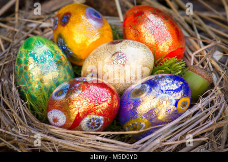 Six colorful painted Easter eggs in a nest Stock Photo