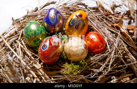 Six colorful painted Easter eggs in a nest Stock Photo