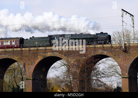 Britannia class British Railways steam locomotive 70013 ‘Oliver Cromwell’ crossing railway viaduct in Central Park, Chelmsford, Essex. Steam train Stock Photo