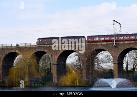 West Coast Railways Class 47 diesel locomotive & train crossing railway viaduct in Central Park, Chelmsford, Essex, line from London Liverpool Street Stock Photo
