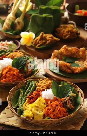 Nasi Campur Bali. Popular traditional Balinese dish of steamed rice served with various side dishes. Stock Photo